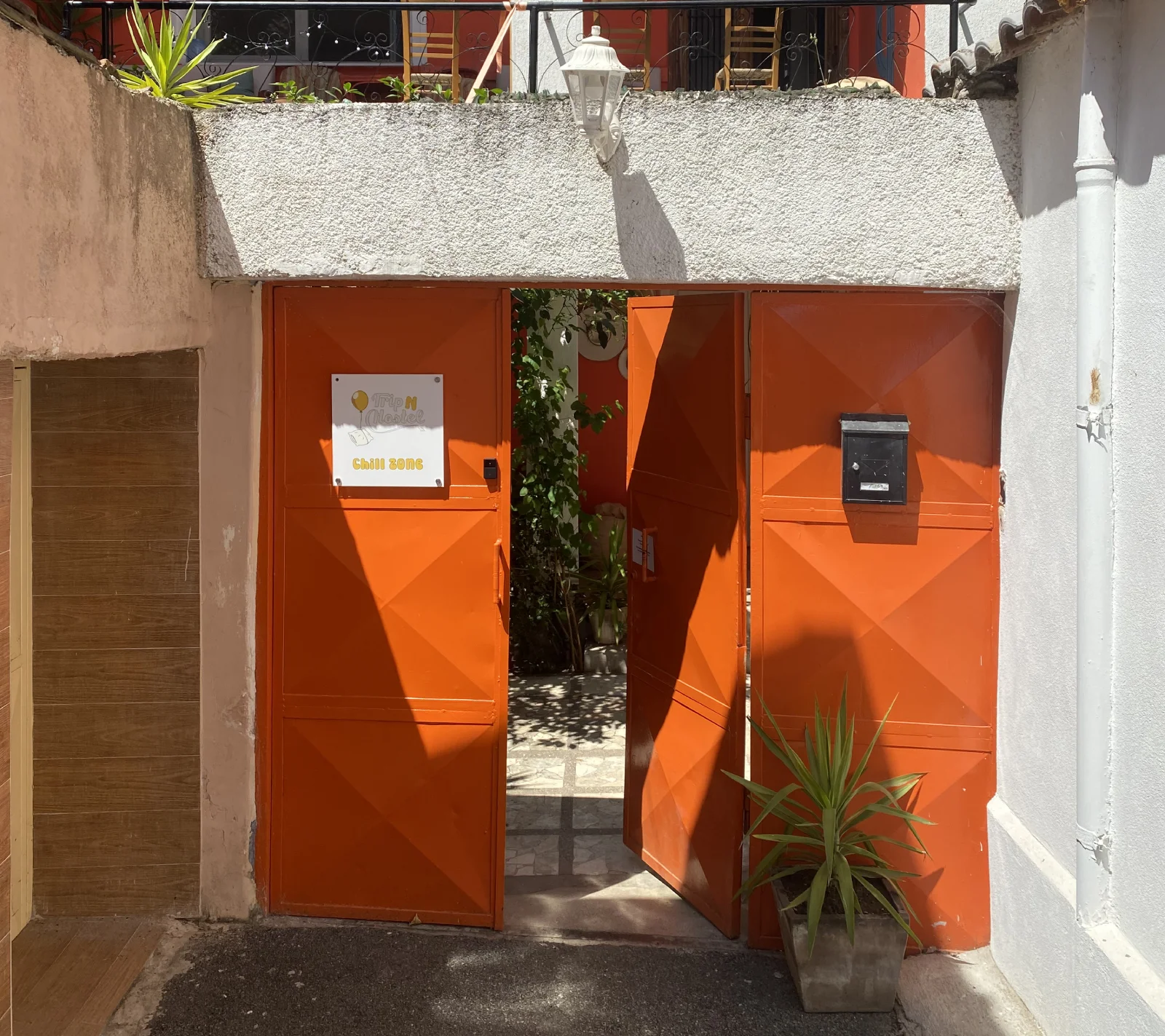 The bright orange gate at Trip'N'Hostel Chill Zone