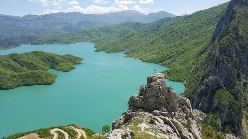 Turquoise water of Bovilla Lake with mountains behind